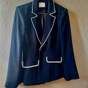 A vintage black Cinq à
Sept blazer with crystal embellishments.